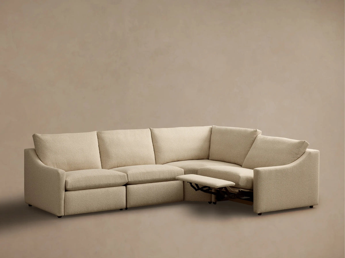 Front view of light beige Kipton Slope Arm Four-Piece Motion Sectional with two extended footrests.