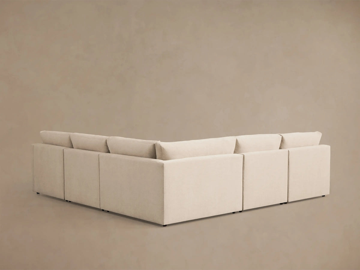 Front view of the cream Kipton Slope Arm Five-Piece Motion Corner Sectional, L-shaped with sloped arms.