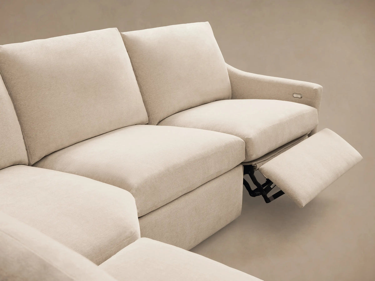 Front view of the Cream Kipton Slope Arm Five-Piece Motion Corner Sectional with one footrest extended.