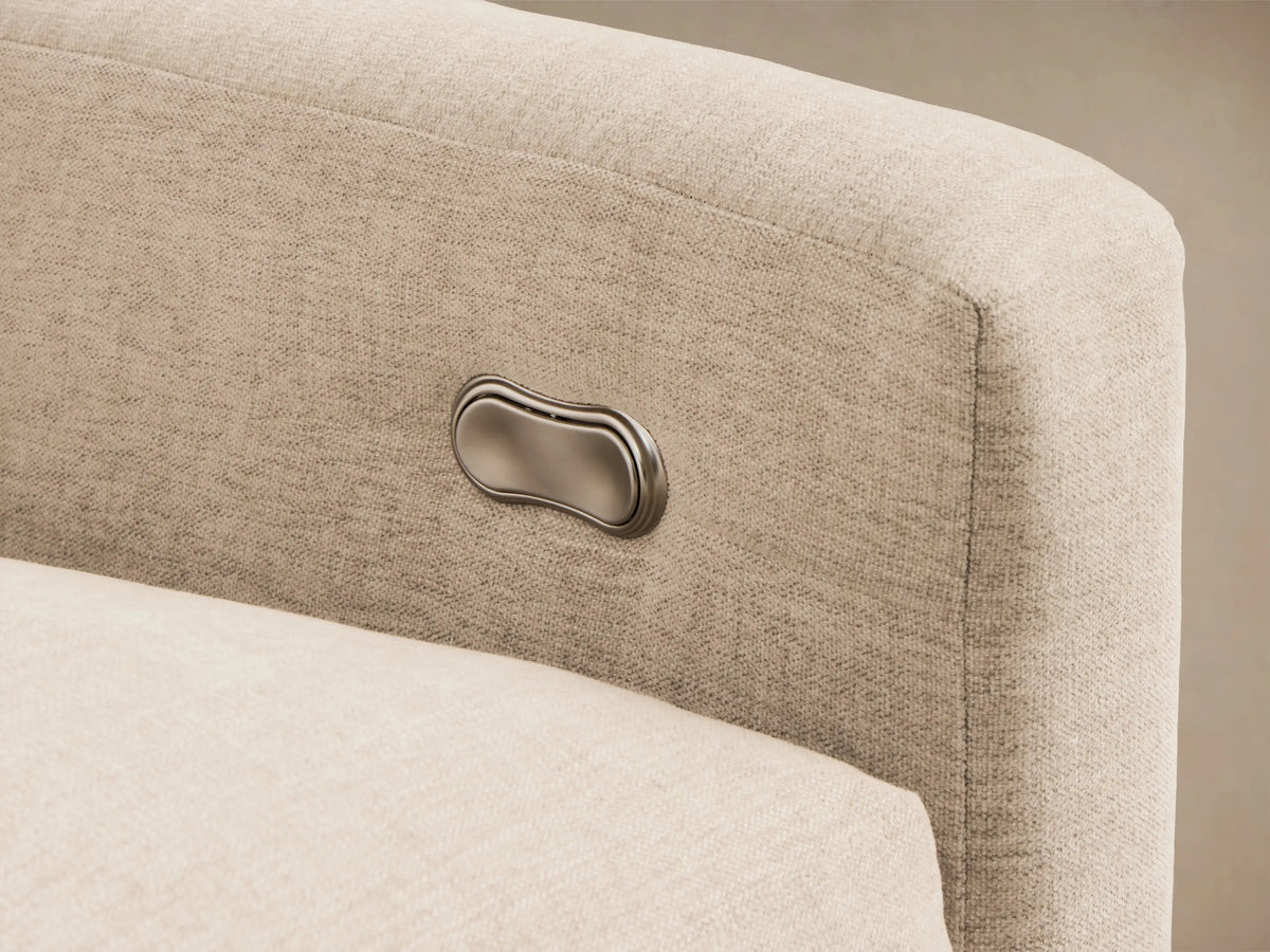 Angled view of a light beige Kipton Slope Arm Five-Piece Motion Corner Sectional with one footrest extended.