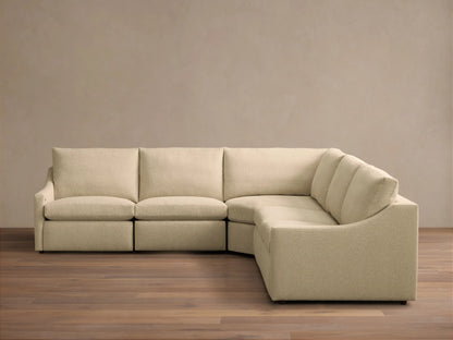 Front view of a Beige Kipton Slope Arm Five-Piece Motion Corner Sectional, showing its L-shape and textured fabric.
