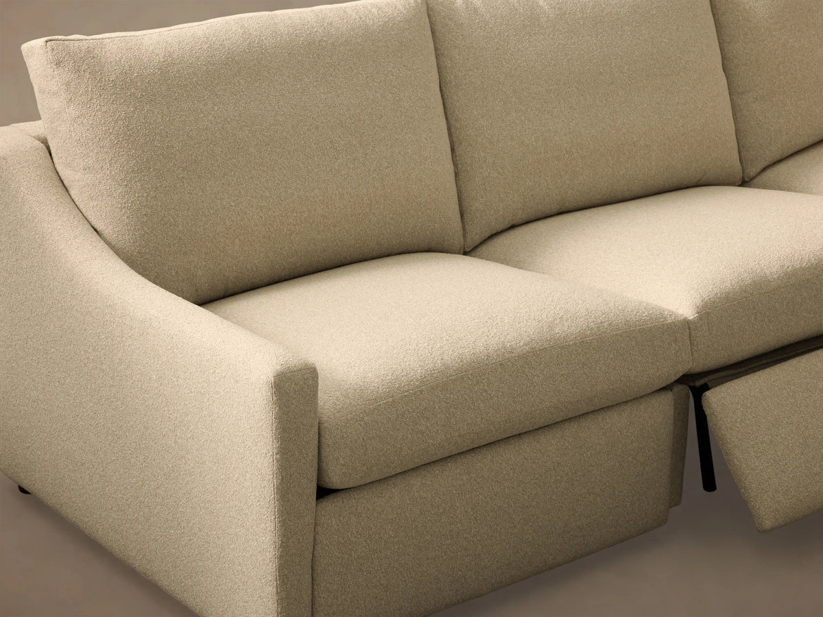 Close-up of the light beige textured fabric on the Kipton Slope Arm Five-Piece Motion Corner Sectional with a metallic motion control button.