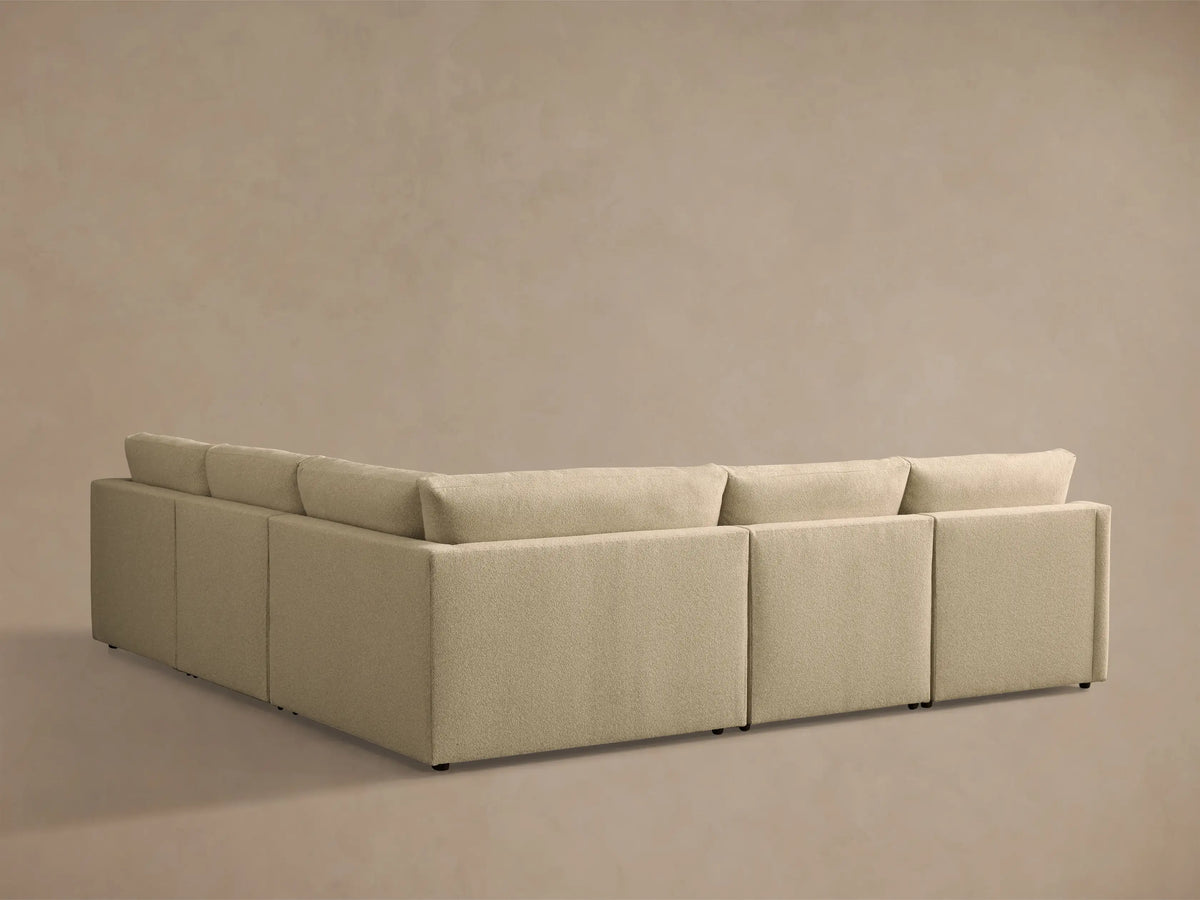 Close-up of the light beige textured Kipton Slope Arm Five-Piece Motion Corner Sectional with an extended footrest.