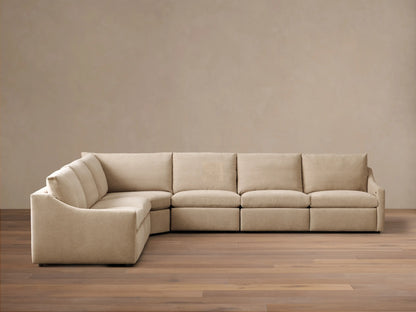 Front view of the light beige Kipton Slope Arm Six-Piece Motion Sectional. The L-shaped sofa has a sloped arm on the left.