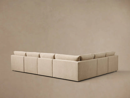 Close-up of a beige Kipton Slope Arm Six-Piece Motion Sectional with an extended footrest on the left.