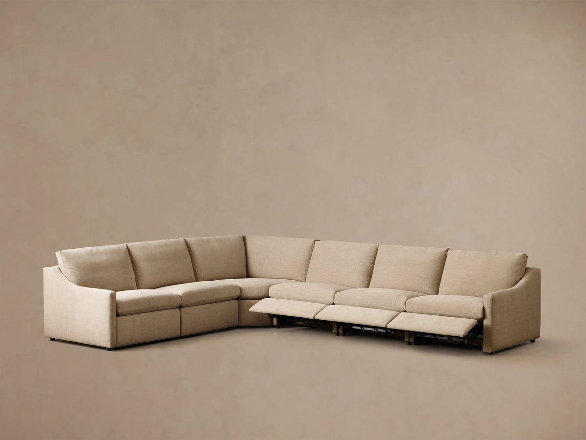 Rear view of the light beige Kipton Slope Arm Six-Piece Motion Sectional, showing its L-shape and back cushions.