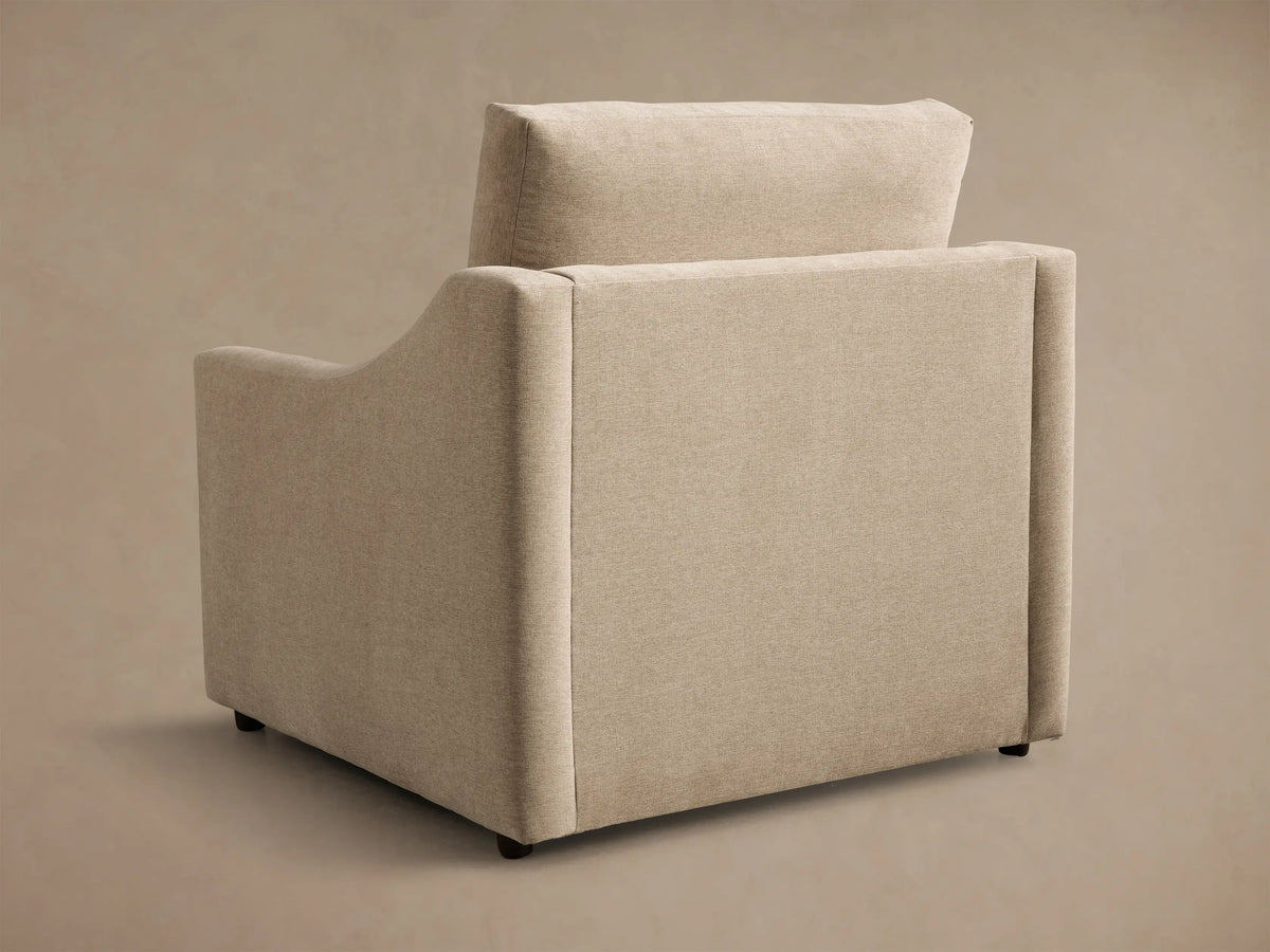 Close-up of a beige Kipton Slope Arm Motion Recliner, partially reclined with extended footrest and armrest control button.