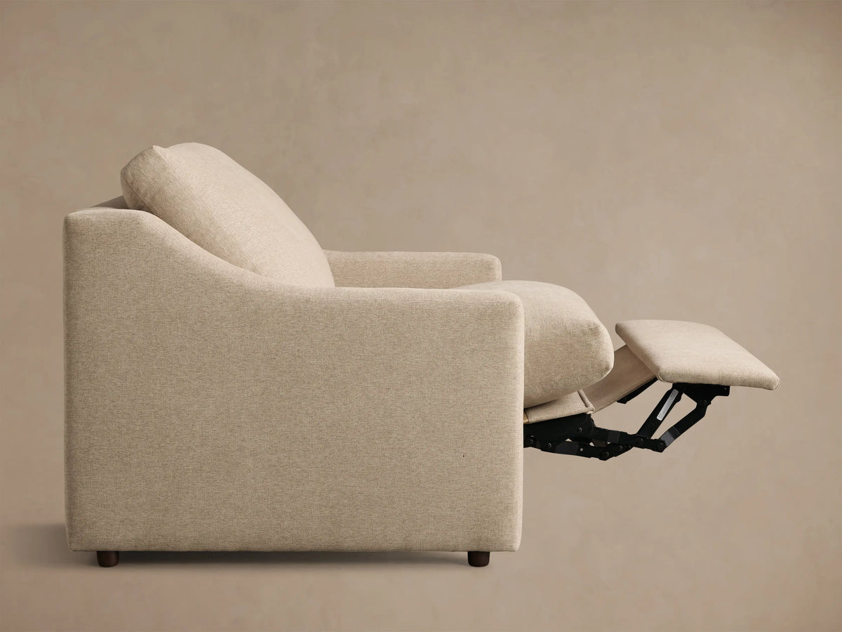 Light beige Kipton Slope Arm Motion Recliner with sloped arms, footrest extended, showing its reclining mechanism.
