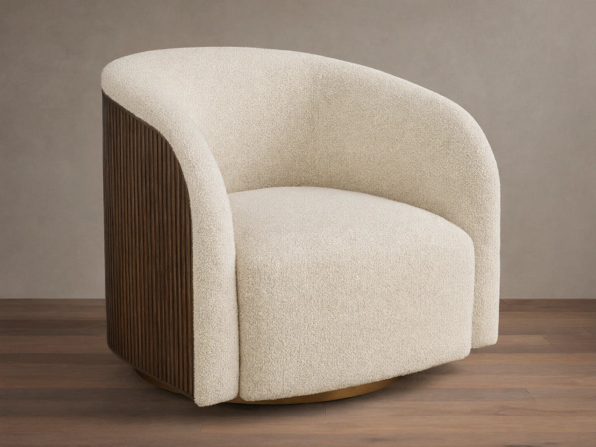 Cream Finnley Swivel Chair with curved, textured upholstery, dark brown vertical wood slats on the side, and a golden swivel base.