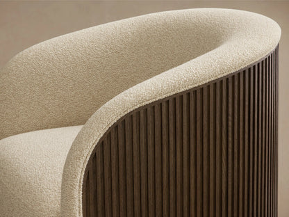 Detail of the curved back and armrest of the Finnley Swivel Chair, featuring cream textured upholstery and a dark wood slatted exterior.