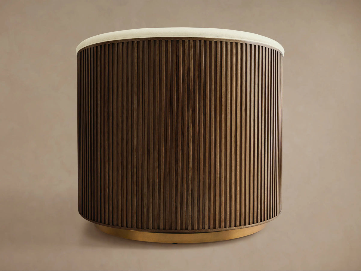Finnley Swivel Chair with curved, wooden slatted back in dark finish, cream cushioned top, on a round wooden base, side view.