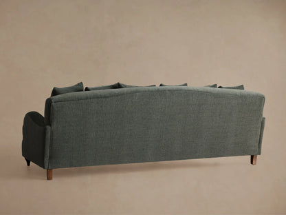 Close-up of a grey Hanover Sofa, showcasing its textured fabric, curved armrest with subtle stitching, plush seat & back cushions.