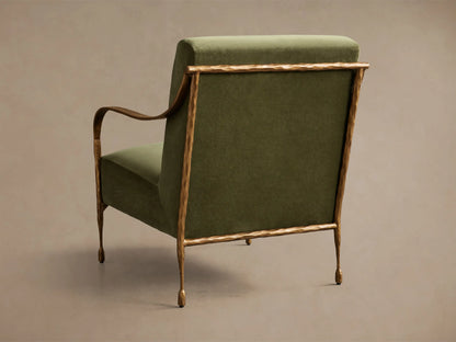 Rear view of the green Gwen Chair, with a hammered brass frame, curved armrests, and tapered legs.