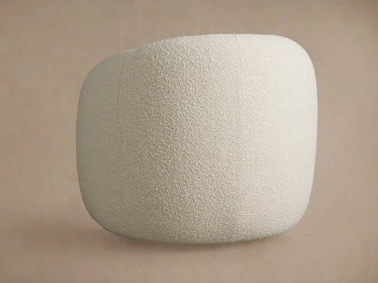Close-up of Fresno Swivel Chair's light cream textured bouclé fabric, highlighting the curved arm and seat.