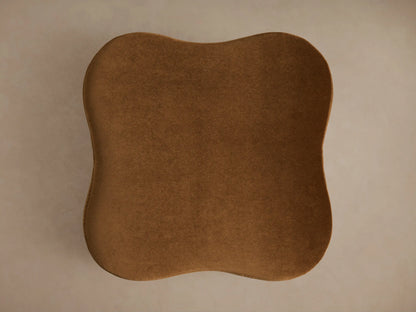 Close-up of the warm brown velvet Barbey Ottoman with Fringe, featuring a cream fringe trim along the bottom edge.