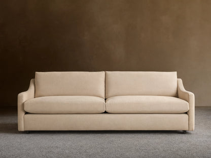 Kipton Slope Arm Sofa in light beige fabric, featuring two seat & two back cushions, with subtly sloped arms, on a wood floor.