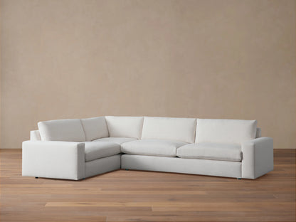 Wide arm two-piece sectional sofa in light beige fabric with clean lines. Positioned on wooden floor against a neutral wall, showcasing modern design.
