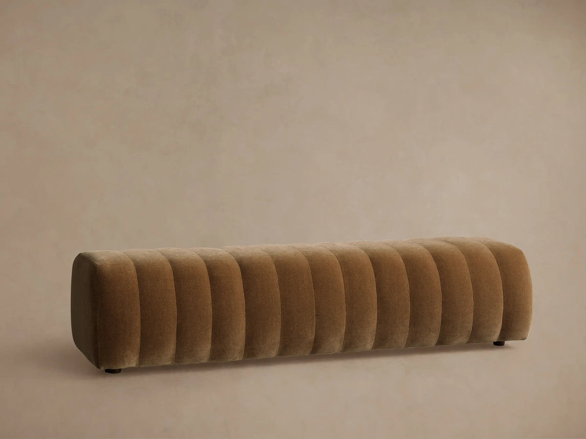 Close-up of Fresno Channel-Stitched Bench with plush, brown fabric and deep, parallel channel tufting, showing texture.