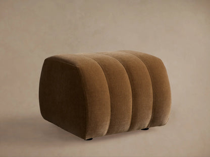 Close-up of the Fresno Channel-Stitched Ottoman in a rich brown fabric, highlighting its elegant curved channel stitching.