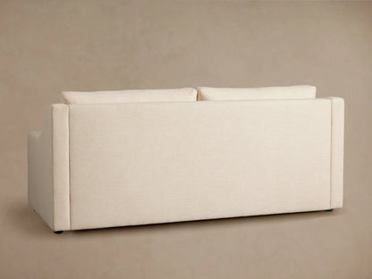 Ashby Luxury Sleeper Sofa in beige fabric, profile view, showing partially pulled-out mattress with quilted pattern, on a neutral background.