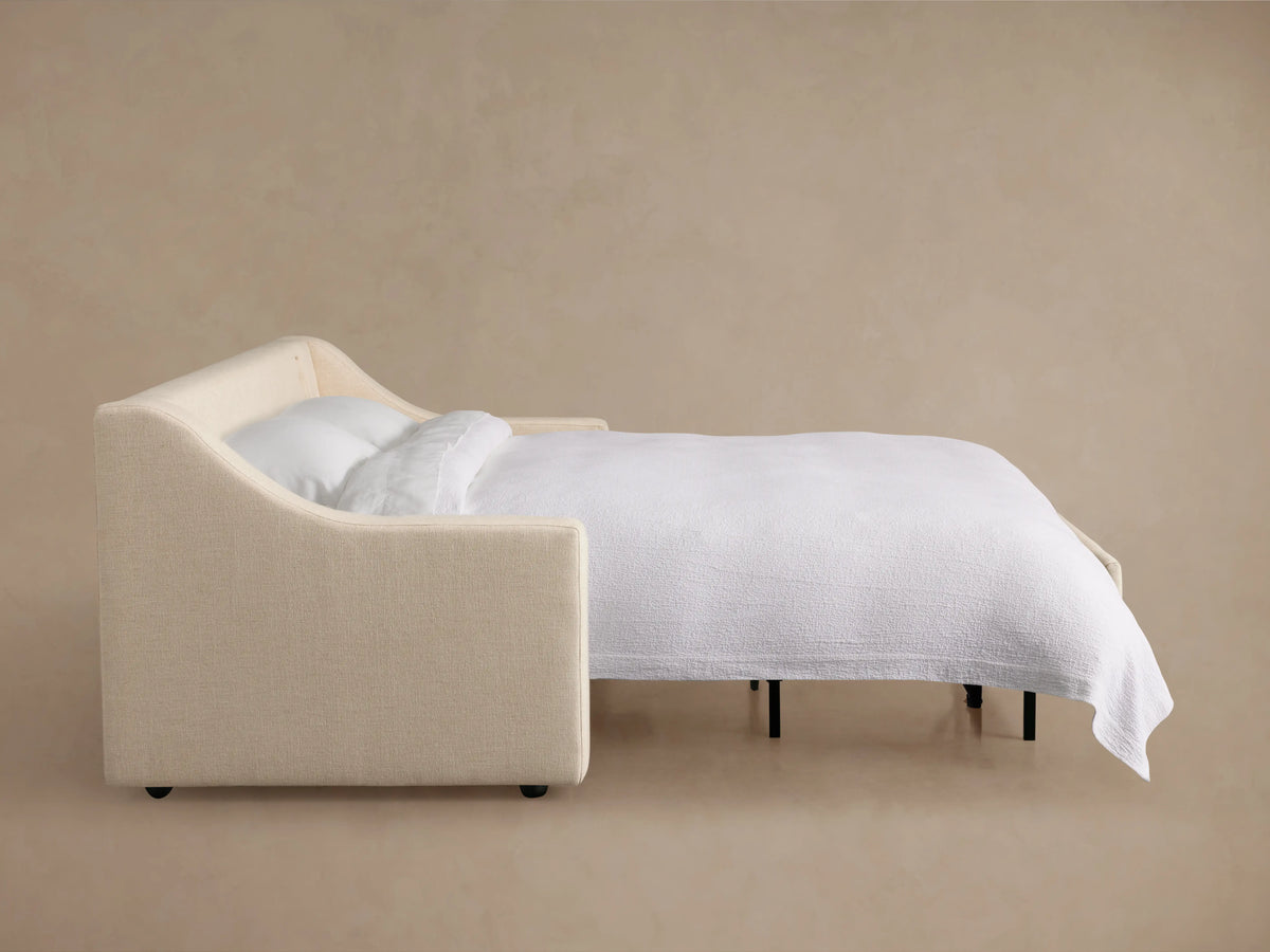 Back view of the Ashby Luxury Sleeper Sofa in a light, neutral fabric showing its clean, rectangular design with two large back cushions.