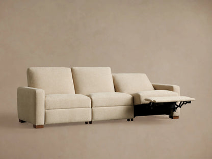 Remington Three-Piece Motion Sofa in light beige fabric. Two left seats are reclined with footrests extended, on a plain background.