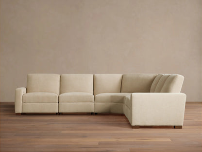 Light beige Remington Five-Piece Motion Corner Sectional, L-shaped, on wooden floor against a plain beige wall.