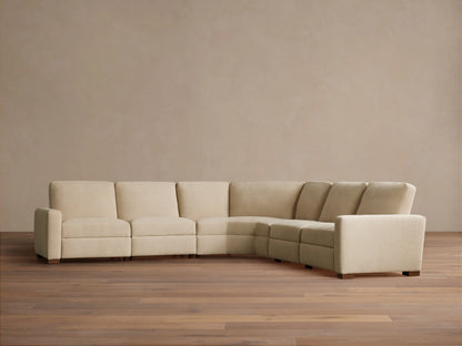 Beige Remington Five-Piece Motion Corner Sectional, one recliner extended, with decorative pillows in a modern living room.
