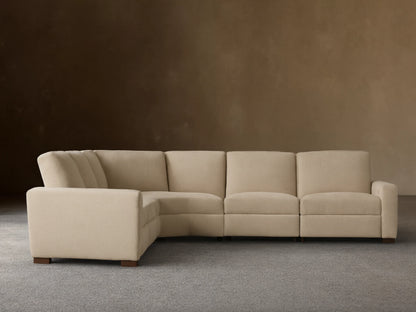 Light beige Remington Five-Piece Motion Corner Sectional, L-shaped, on wooden floor against a plain beige wall.