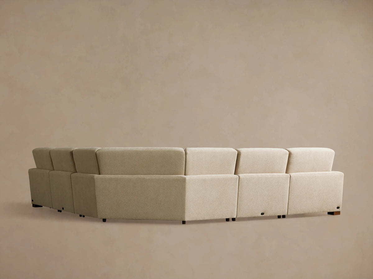 Angled close-up of the Remington Five-Piece Motion Corner Sectional. A light beige textured fabric section is reclined, footrest elevated.