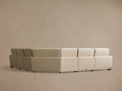 Angled close-up of the Remington Five-Piece Motion Corner Sectional. A light beige textured fabric section is reclined, footrest elevated.