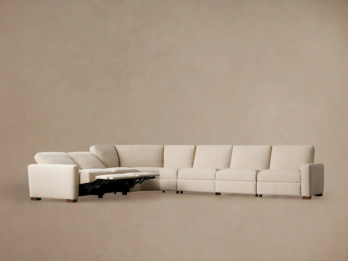 Light beige U-shaped Remington Six-Piece Motion Sectional with two right recliners partially extended, against a neutral wall.