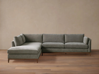 Bainbridge Two-Piece Bumper Sectional in L-shape, upholstered in gray fabric, with a left-facing chaise, on wood floor.