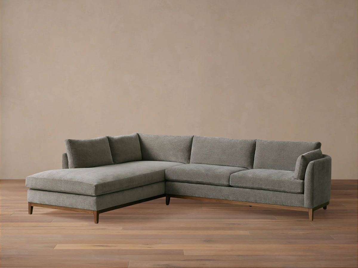 Bainbridge Two-Piece Bumper Sectional in L-shape, upholstered in gray fabric, with a left-facing chaise, on wood floor.
