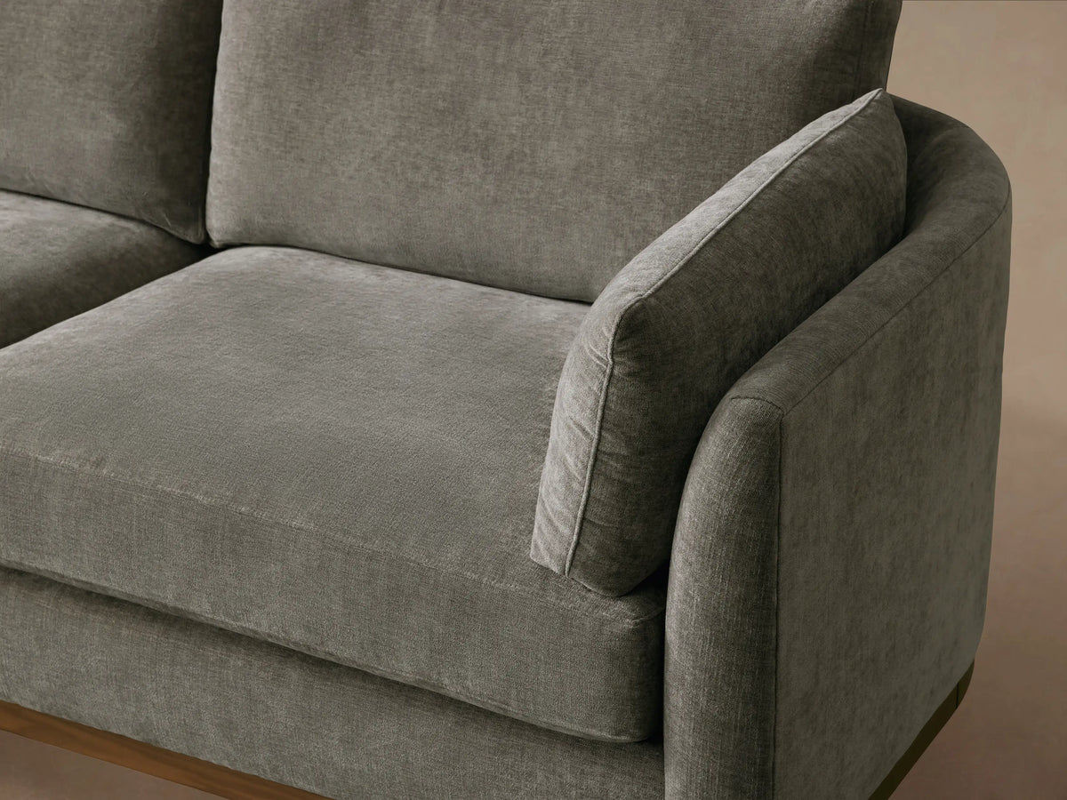 Bainbridge Two-Piece Bumper Sectional: L-shaped gray sofa with textured fabric, left-facing chaise, and exposed wooden base.
