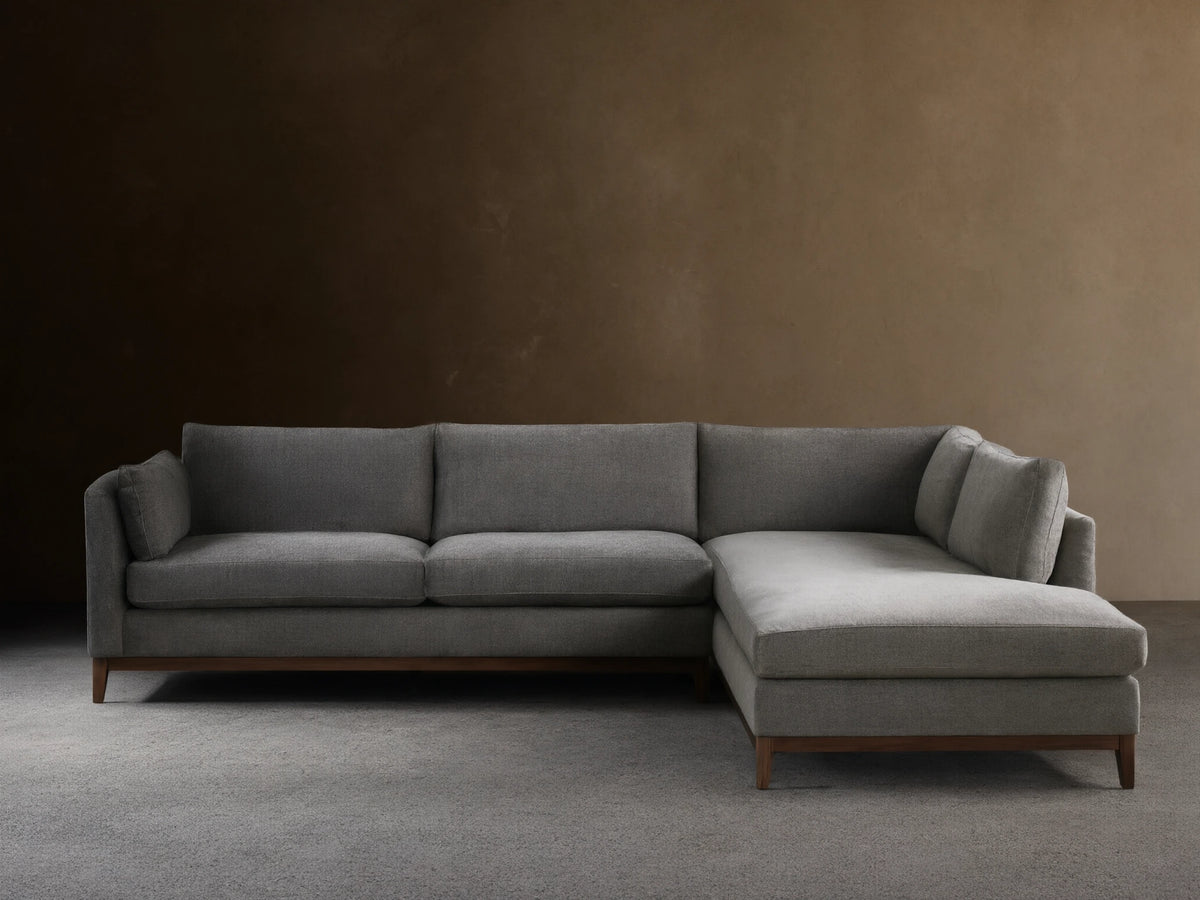 Bainbridge Two-Piece Bumper Sectional in L-shape, upholstered in gray fabric, with a left-facing chaise, on wood floor.