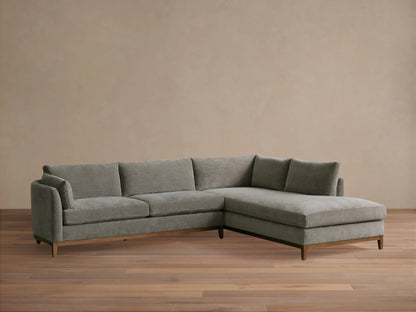 Bainbridge Two-Piece Bumper Sectional, grey fabric with wooden base, L-shaped, right-hand facing chaise, on wood floor.
