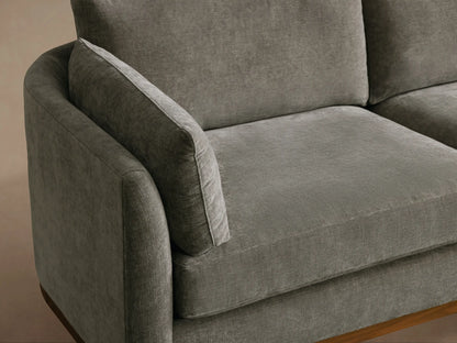 Gray Bainbridge Two-Piece Bumper Sectional, L-shaped with a right bumper chaise, visible dark wood frame and legs.