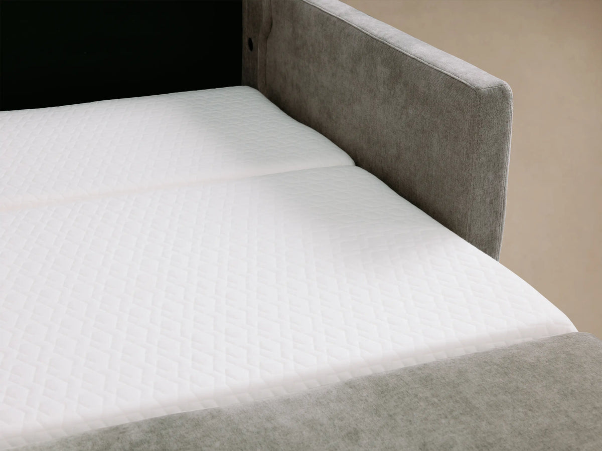 Reece Sleeper Sofa in light grey fabric, front view, with two back & two seat cushions, square arms with stitched detail.