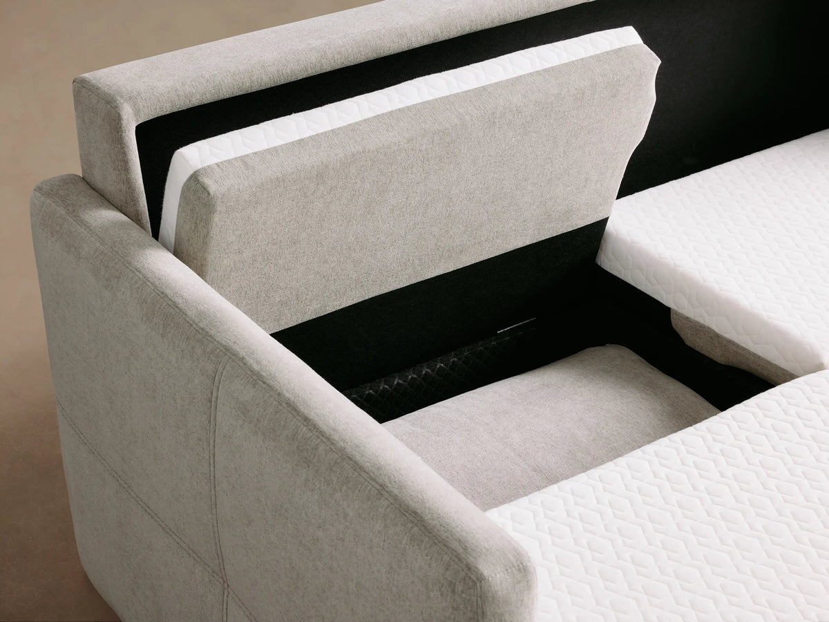Opened Reece Sleeper Sofa with white quilted mattress, gray upholstered headrest, and base.