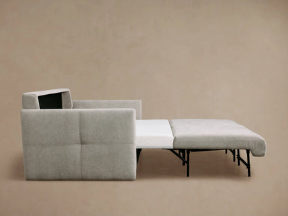 Back and side view of a light gray Reece Sleeper Sofa, showing two back cushions and a subtly stitched left armrest.