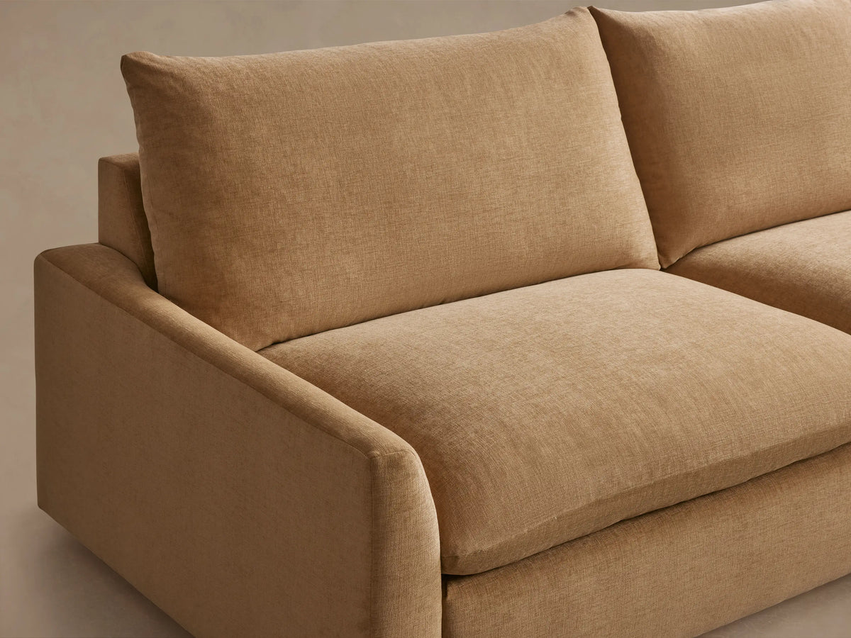 Calistoga Three-Piece Corner Sectional in tan fabric, L-shaped, with plush cushions and a minimalist design on a wooden floor.