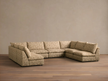Front view of beige multi-tone woven Calistoga Eight-Piece Sectional, L-shaped, with plump cushions on a wood floor.