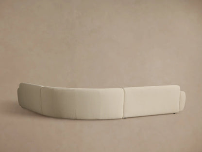 Close-up of the Gianni Three-Piece Corner Sectional, featuring a curved armrest and textured light beige fabric.