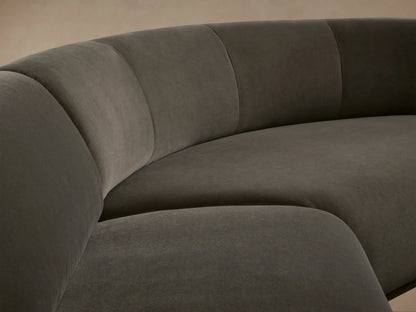 L-shaped Gianni Three-Piece Sectional, dark grey velvet, featuring a curved corner and a straight section with a rolled arm.