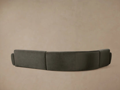 Curved Gianni Three-Piece Sectional in charcoal velvet, featuring plush, rounded backrests and seat cushions.