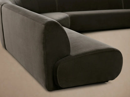Gianni Five-Piece Armless Curved Sectional sofa in dark grey velvet, with smooth, low profile, on a wooden floor.