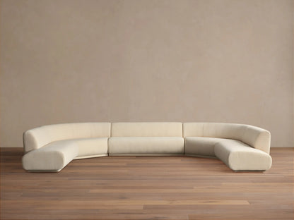 Cream Gianni Five-Piece Curved Bumper Sectional, low-profile and modular, on wood floor against a plain wall.