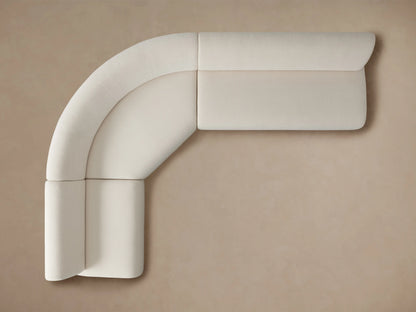 Gianni Three-Piece Sectional in cream fabric shown from the back, highlighting its curved design and smooth upholstery.