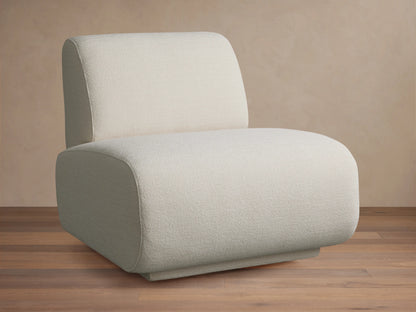 Gianni Swivel Chair in a textured, creamy white fabric, shown front-facing. Features a rounded, plush seat and backrest on a wooden floor.